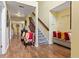 Inviting foyer with hardwood flooring, a staircase, and bench seating at 10611 Armstead Ave, Indianapolis, IN 46234
