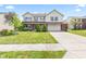 Charming two-story home featuring a well-manicured lawn, brick accents, and an attached two-car garage at 10611 Armstead Ave, Indianapolis, IN 46234
