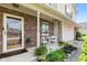 Inviting front porch with brick siding, seating, and decorative plants at 10611 Armstead Ave, Indianapolis, IN 46234