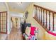Hallway with wood floors, staircase, and views into other rooms at 10611 Armstead Ave, Indianapolis, IN 46234