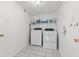 Functional laundry room with modern washer and dryer units, plus extra storage shelves at 10611 Armstead Ave, Indianapolis, IN 46234