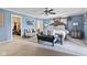 Comfortable main bedroom features a ceiling fan, a sitting area, and an ensuite bathroom at 10611 Armstead Ave, Indianapolis, IN 46234
