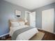 Stylish bedroom with board and batten paneling, hardwood floors, and ample closet space at 1217 S Ewing St, Indianapolis, IN 46203