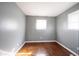 This bedroom features neutral walls, window for natural light, and hardwood floors at 1217 S Ewing St, Indianapolis, IN 46203
