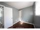 Bedroom featuring hardwood floors, white trim, grey walls, and a window with natural light at 1217 S Ewing St, Indianapolis, IN 46203