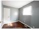 This bedroom features gray walls, window for natural light, and hardwood floors at 1217 S Ewing St, Indianapolis, IN 46203