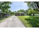 Inviting home with a long driveway, well-maintained lawn, and mature trees adding to its curb appeal at 1217 S Ewing St, Indianapolis, IN 46203