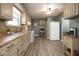 Well-lit kitchen with neutral cabinets, white appliances, and hardwood floors at 1217 S Ewing St, Indianapolis, IN 46203