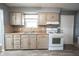 Well-lit kitchen featuring essential appliances, plenty of cabinets, and a functional layout at 1217 S Ewing St, Indianapolis, IN 46203