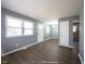 Open living room with grey walls, large windows, and new wood laminate flooring at 1217 S Ewing St, Indianapolis, IN 46203