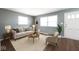 Inviting living room featuring wood floors, stylish decor, and abundant natural light at 1217 S Ewing St, Indianapolis, IN 46203
