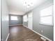 Bright, open living area features gray walls, large windows, and modern chandelier at 1217 S Ewing St, Indianapolis, IN 46203