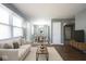 Bright living room leading to dining area, featuring hard wood flooring and abundant light at 1217 S Ewing St, Indianapolis, IN 46203
