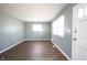 Living room with gray walls, bright windows, and newly installed laminate flooring at 1217 S Ewing St, Indianapolis, IN 46203