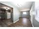 This light-filled living room flows into the kitchen with hard wood flooring and modern neutral paint at 1217 S Ewing St, Indianapolis, IN 46203