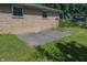 Backyard concrete patio with a low brick house in the background at 1217 S Ewing St, Indianapolis, IN 46203