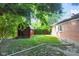 Green backyard with shed beside brick house and white piping at 1231 N Graham Ave, Indianapolis, IN 46219