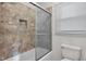 Modern bathroom with neutral-colored tiles, shower and toilet at 1231 N Graham Ave, Indianapolis, IN 46219