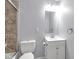 Bathroom featuring a vanity with sink, a toilet, and a shower with glass door at 1231 N Graham Ave, Indianapolis, IN 46219
