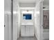 Hallway view of modern vanity and tiled shower with sliding glass doors at 1231 N Graham Ave, Indianapolis, IN 46219