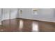 Bedroom with light gray walls, wood-look flooring, and natural light from two windows at 1231 N Graham Ave, Indianapolis, IN 46219