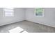 Bedroom with light gray walls, gray carpet flooring, and two windows for natural light at 1231 N Graham Ave, Indianapolis, IN 46219