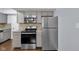 Kitchen with stainless steel appliances, range, microwave and refrigerator, and neutral colored cabinets at 1231 N Graham Ave, Indianapolis, IN 46219