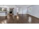 Open-concept living room and kitchen with modern stainless steel appliances, stylish cabinetry, and hardwood floors at 1231 N Graham Ave, Indianapolis, IN 46219