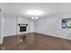 Bright living room with a fireplace, fresh paint, hardwood floors, and lots of natural light at 1231 N Graham Ave, Indianapolis, IN 46219