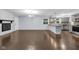 Spacious living room with hardwood floors, a decorative fireplace, and abundant natural light from the window at 1231 N Graham Ave, Indianapolis, IN 46219