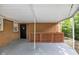 Covered patio overlooking backyard features wood railing and brick exterior at 1231 N Graham Ave, Indianapolis, IN 46219