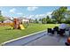 Large backyard showing playground, green space and patio with furniture at 12404 Guy Way, Indianapolis, IN 46236