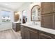Well-lit bathroom with double vanities, modern fixtures, and wood-look flooring at 12404 Guy Way, Indianapolis, IN 46236
