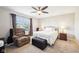 Relaxing bedroom with a cozy chair, bed with soft white bedding, window and natural light at 12404 Guy Way, Indianapolis, IN 46236