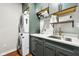 Functional laundry room with stacked washer and dryer, sink, ample storage, and counter space at 12404 Guy Way, Indianapolis, IN 46236