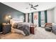 Serene main bedroom featuring a ceiling fan, accent wall and ample natural light at 12404 Guy Way, Indianapolis, IN 46236