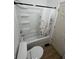 Bathroom with a white shower and tub, toilet, and light brown floors at 1256 Kappes St, Indianapolis, IN 46221