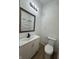 Bathroom with white vanity with black hardware, toilet, and bright lighting at 1256 Kappes St, Indianapolis, IN 46221