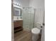 Bathroom featuring light wood vanity, mirror, walk in shower and toilet at 1256 Kappes St, Indianapolis, IN 46221