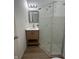Bathroom with light wood vanity, mirror, and walk in shower at 1256 Kappes St, Indianapolis, IN 46221