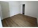 Bedroom featuring light brown laminate flooring, with closet, and an interior door at 1256 Kappes St, Indianapolis, IN 46221
