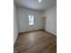 A sunlit bedroom with wood-look flooring and a window at 1256 Kappes St, Indianapolis, IN 46221