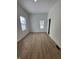 Bedroom with two windows, laminate flooring, and a closet with sliding doors at 1256 Kappes St, Indianapolis, IN 46221