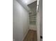 Walk in closet with built in shelving and laminate flooring at 1256 Kappes St, Indianapolis, IN 46221
