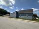 Exterior view of a newly renovated home featuring blue vinyl siding and crisp, white-trimmed windows at 1256 Kappes St, Indianapolis, IN 46221
