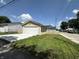 A detached single-car garage with a concrete driveway, white garage door, and light tan siding at 1256 Kappes St, Indianapolis, IN 46221