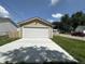 A single-car garage with a white door and a concrete driveway at 1256 Kappes St, Indianapolis, IN 46221