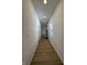 Long hallway featuring wood-look flooring, fresh white walls, and recessed lighting at 1256 Kappes St, Indianapolis, IN 46221