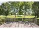 Large deck in a grassy backyard offers a great place for relaxing and enjoying nature at 1311 Flintlock Dr, Greenwood, IN 46143
