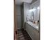 Bathroom with double vanity, oval mirror, and updated lighting at 1311 Flintlock Dr, Greenwood, IN 46143